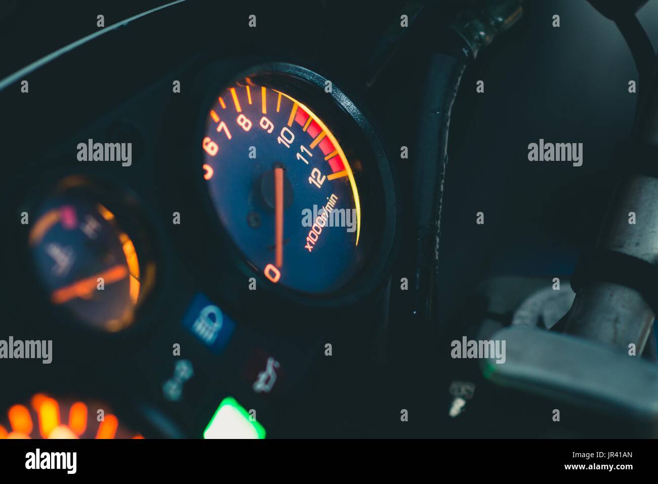 Illuminated motorbike control panel with speedometer and revs counter