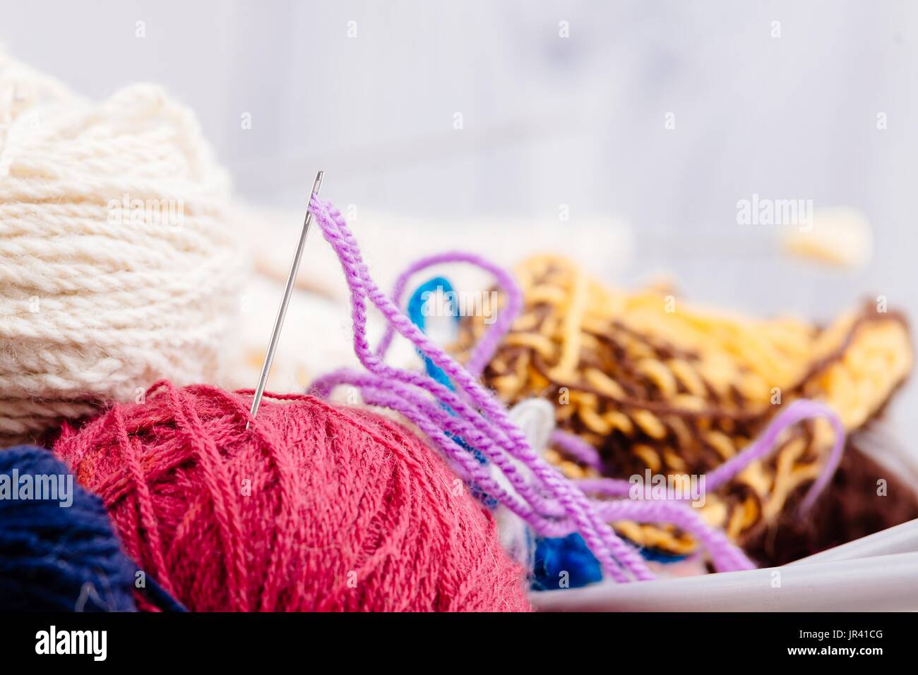 Colorful wool balls and needles in wooden basket. Wool knitting Stock ...