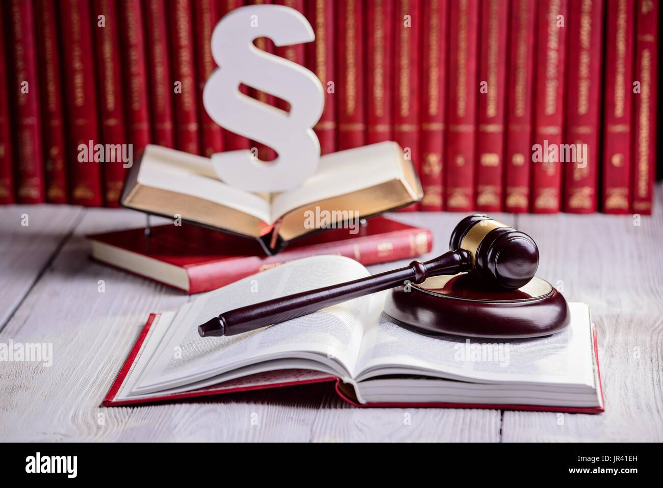 Symbols of law in court library. Judge gavel, wooden paragraph and ...