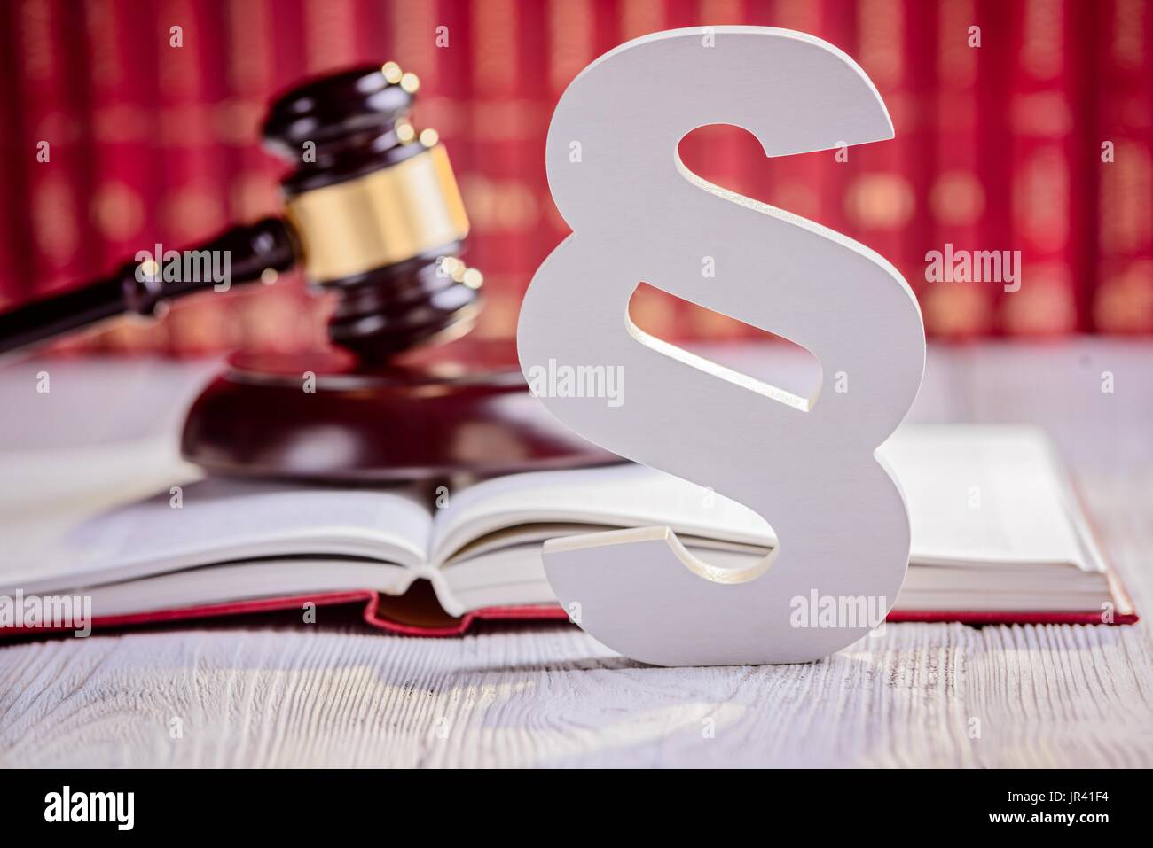 Symbols of law in court library. Judge gavel, wooden paragraph and ...