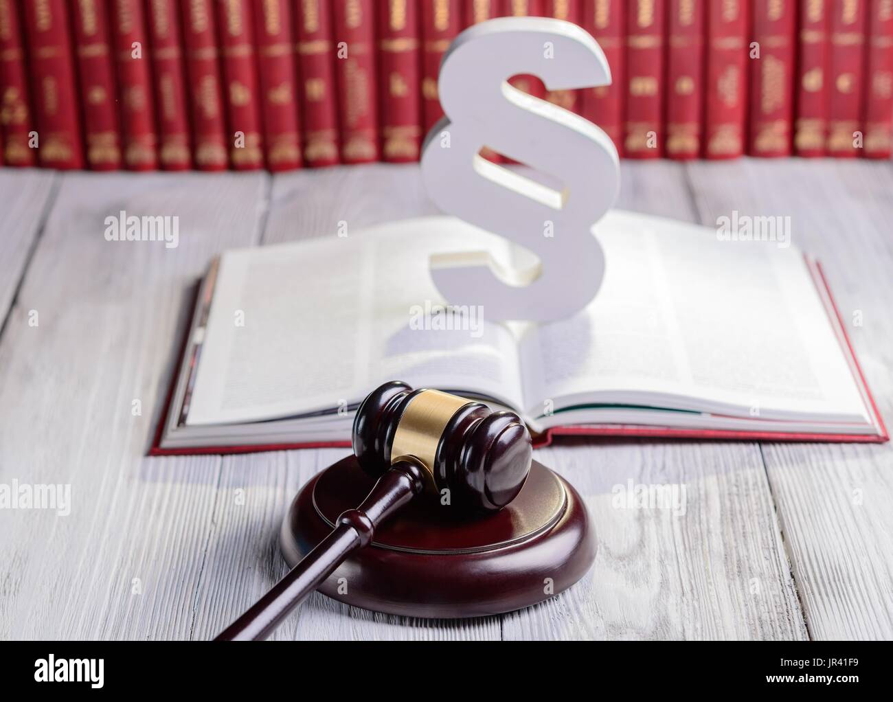 Symbols of law in court library. Judge gavel, wooden paragraph and ...