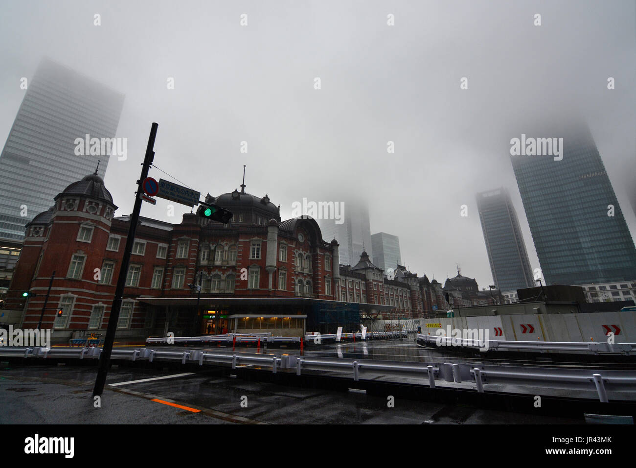 TOKYO, JAPAN - APRIL 8, 2017 - Skyscraper buildings around Tokyo Station disappear into thick morning fog in Japan's urban capital Stock Photo