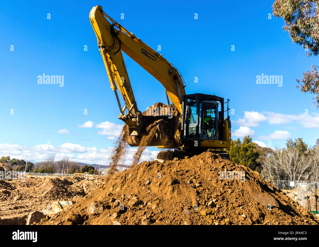 Front end loader works to move pile of dirt Stock Photo Alamy