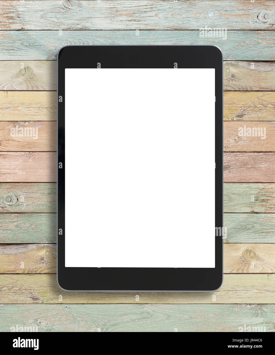 Black tablet pc on old wood colorful background Stock Photo