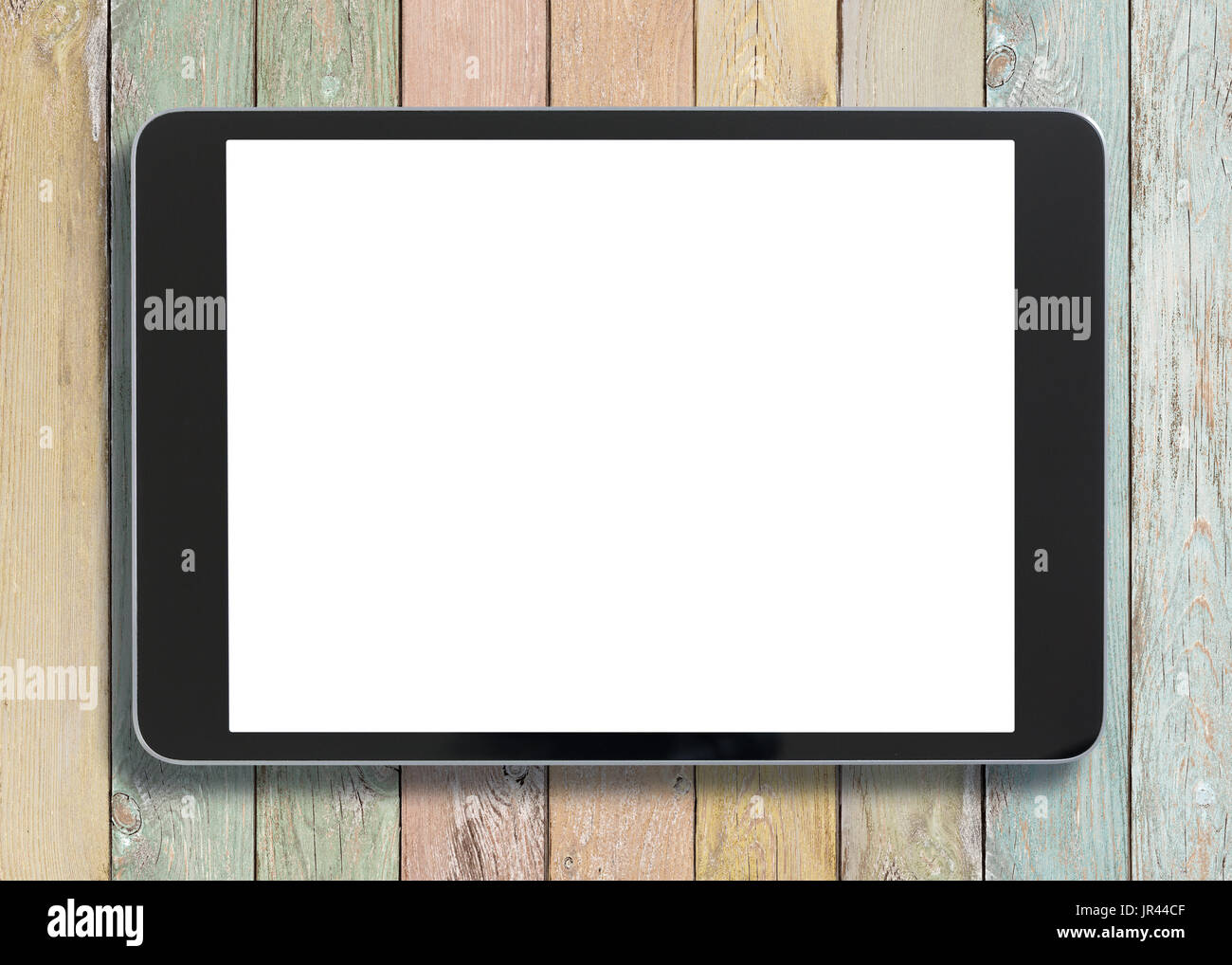 Black tablet pc looking similar to ipad on old colorful wood background Stock Photo