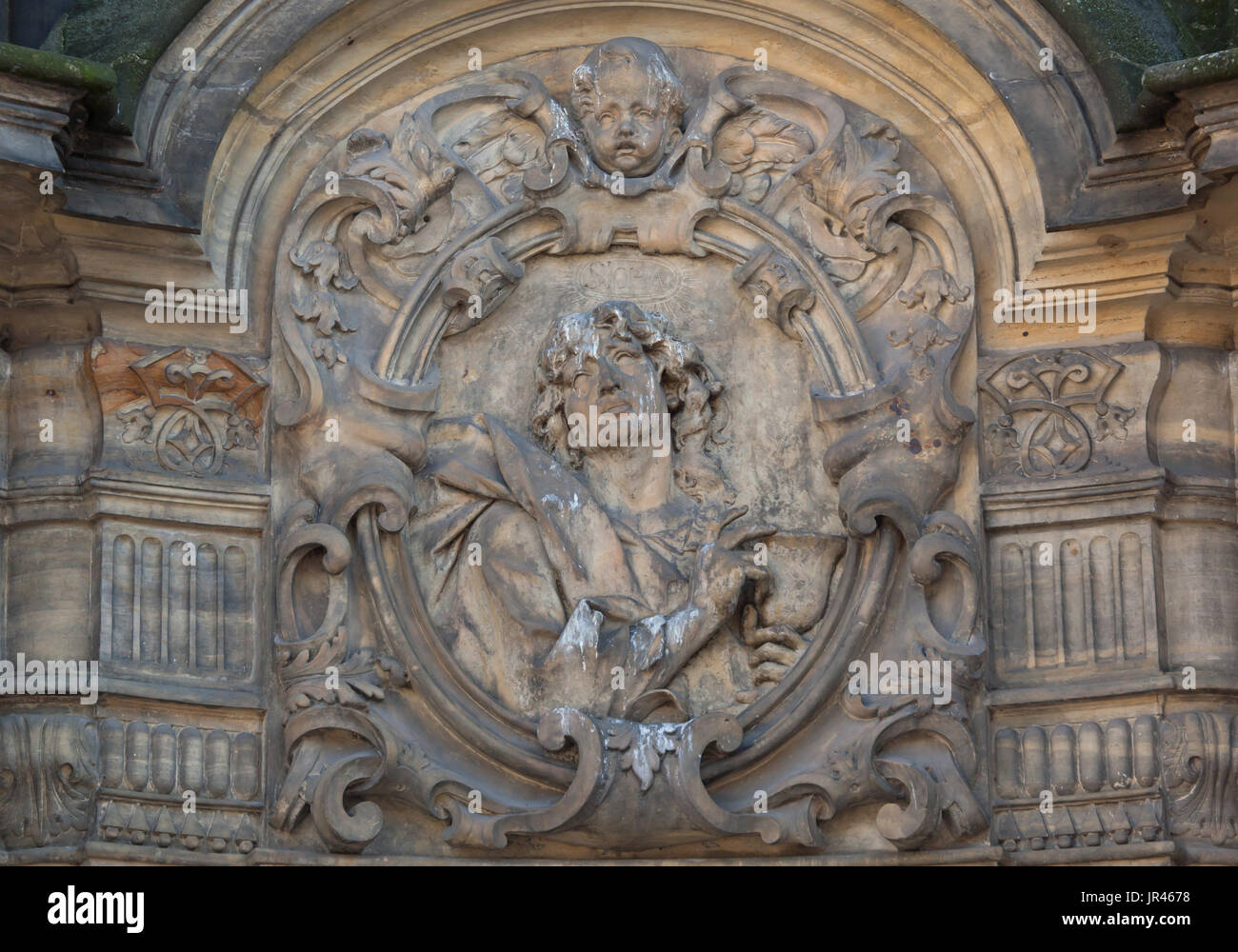 Saint John the Evangelist depicted on the Holy Trinity Column (Sloup Nejsvětější Trojice) in Olomouc, Czech Republic. Stock Photo