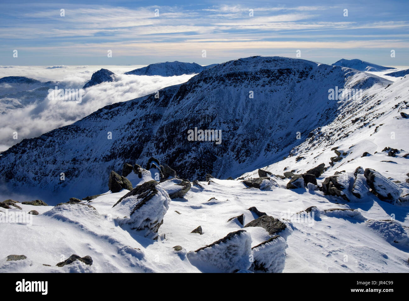 View across Cwm Lloer to Pen Yr Ole Wen in Carneddau mountains of Snowdonia National Park during a temperature inversion in winter. Wales UK Stock Photo