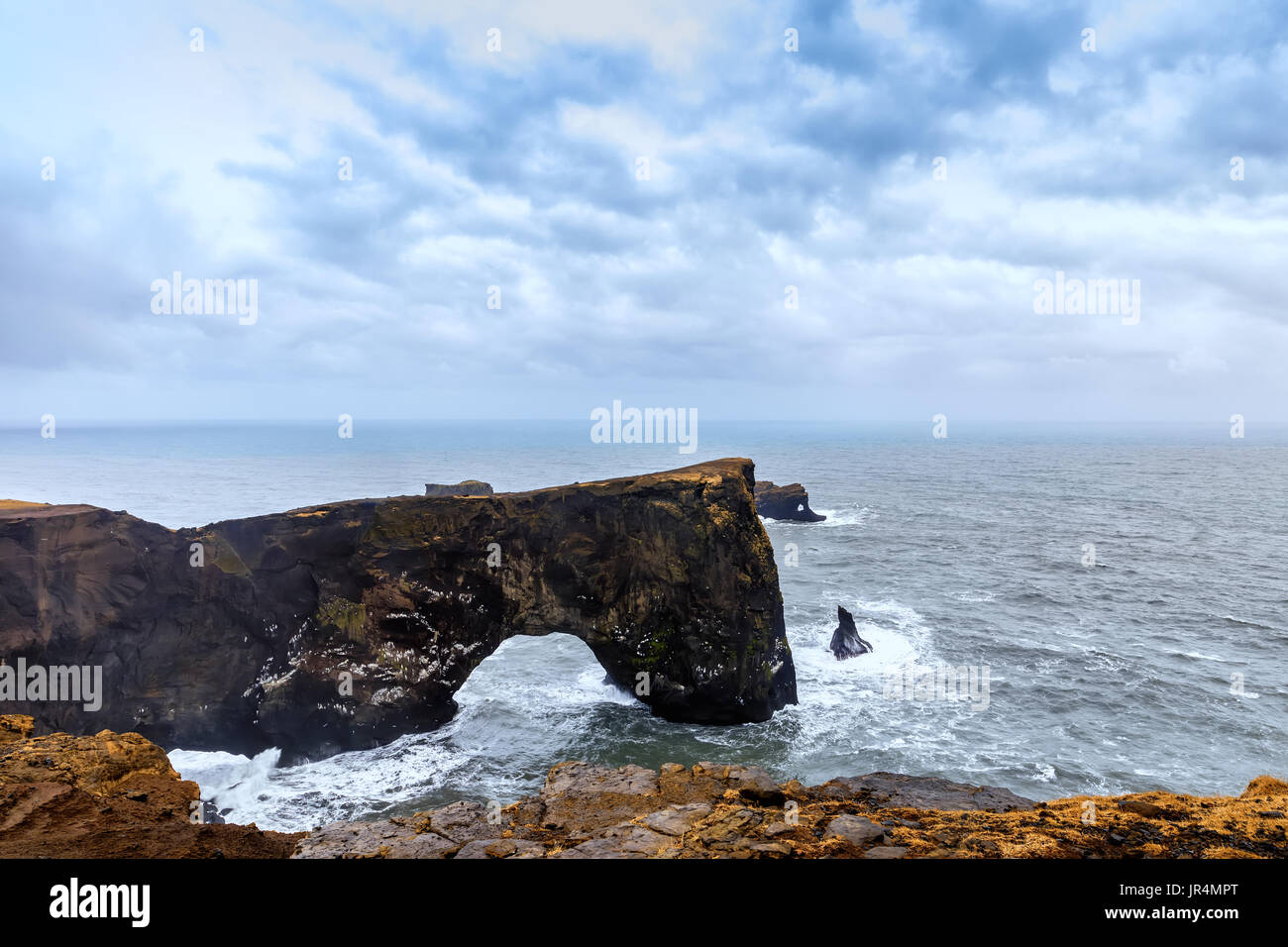 Magnificent rock arch at Dyrholaey, Iceland. Dyrholaey means the hill island with the door hole. It is 120 m high Stock Photo
