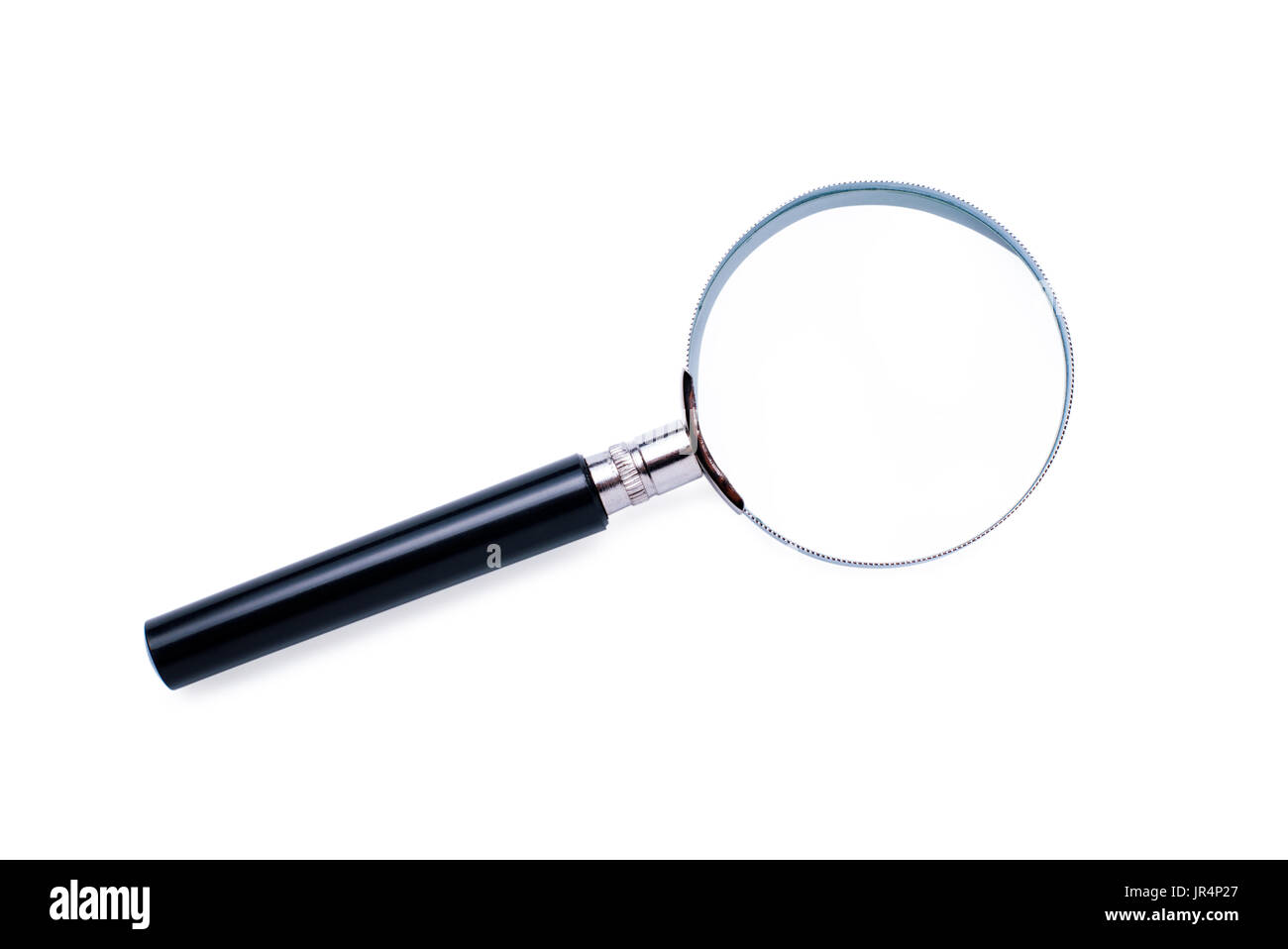 Isolated circular magnifying glass with a metal surround lying on a