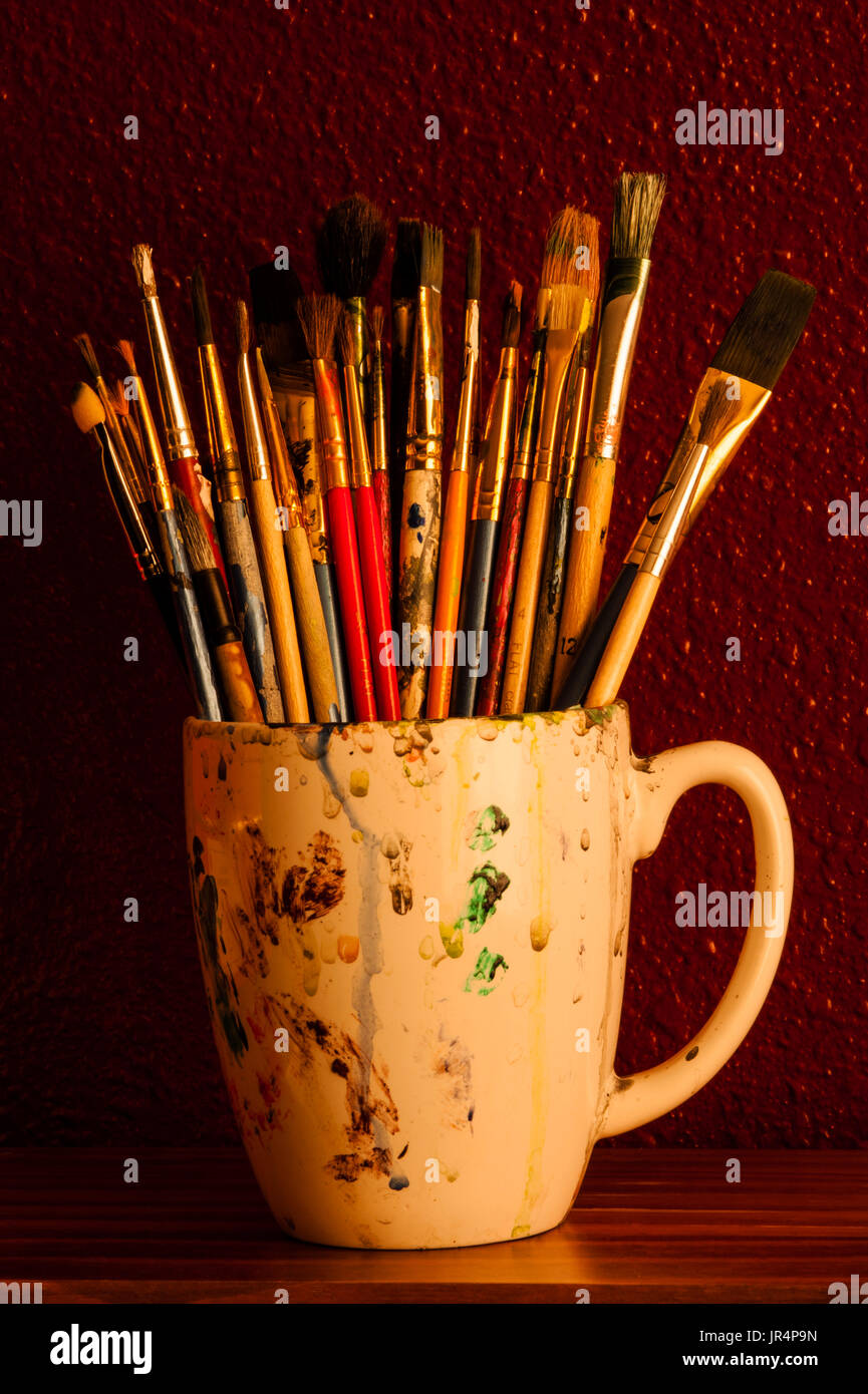 Multicolored paint brushes in cup Stock Photo - Alamy