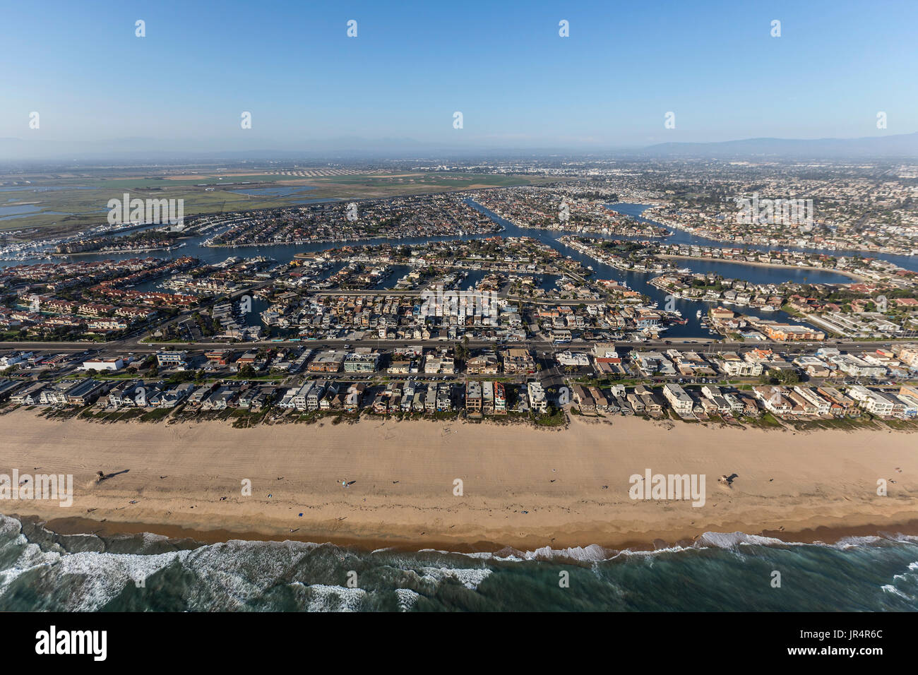 Aerial of Sunset Beach shoreline homes in Orange County, California. Stock Photo