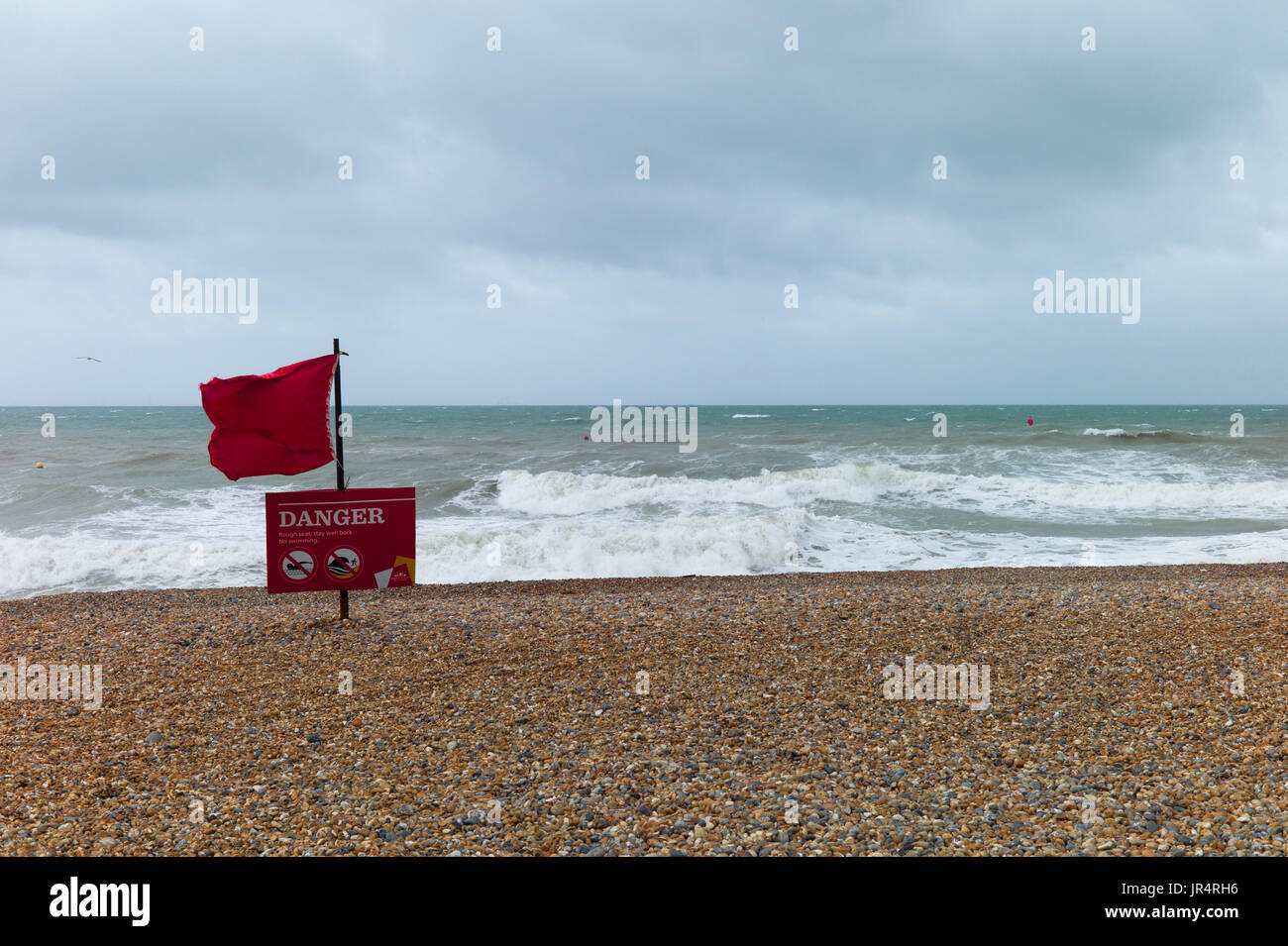 Red warning flag on Brighton beach Stock Photo