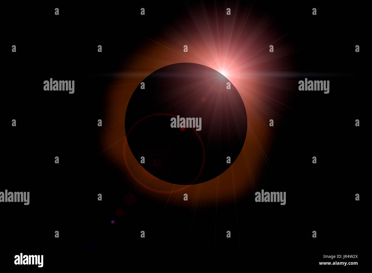 Solar eclipse with orange halo on black sky background. Stock Photo