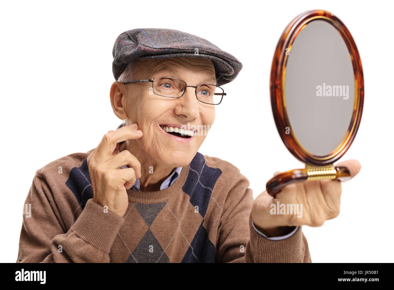 Elderly man looking at a mirror and smiling isolated on white background Stock Photo