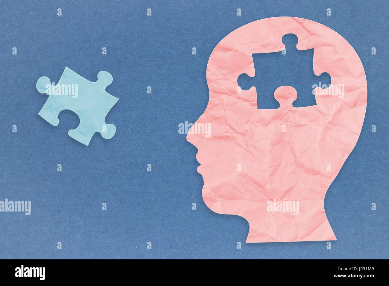 mental health concept with side face and jigsaw pieces Stock Photo