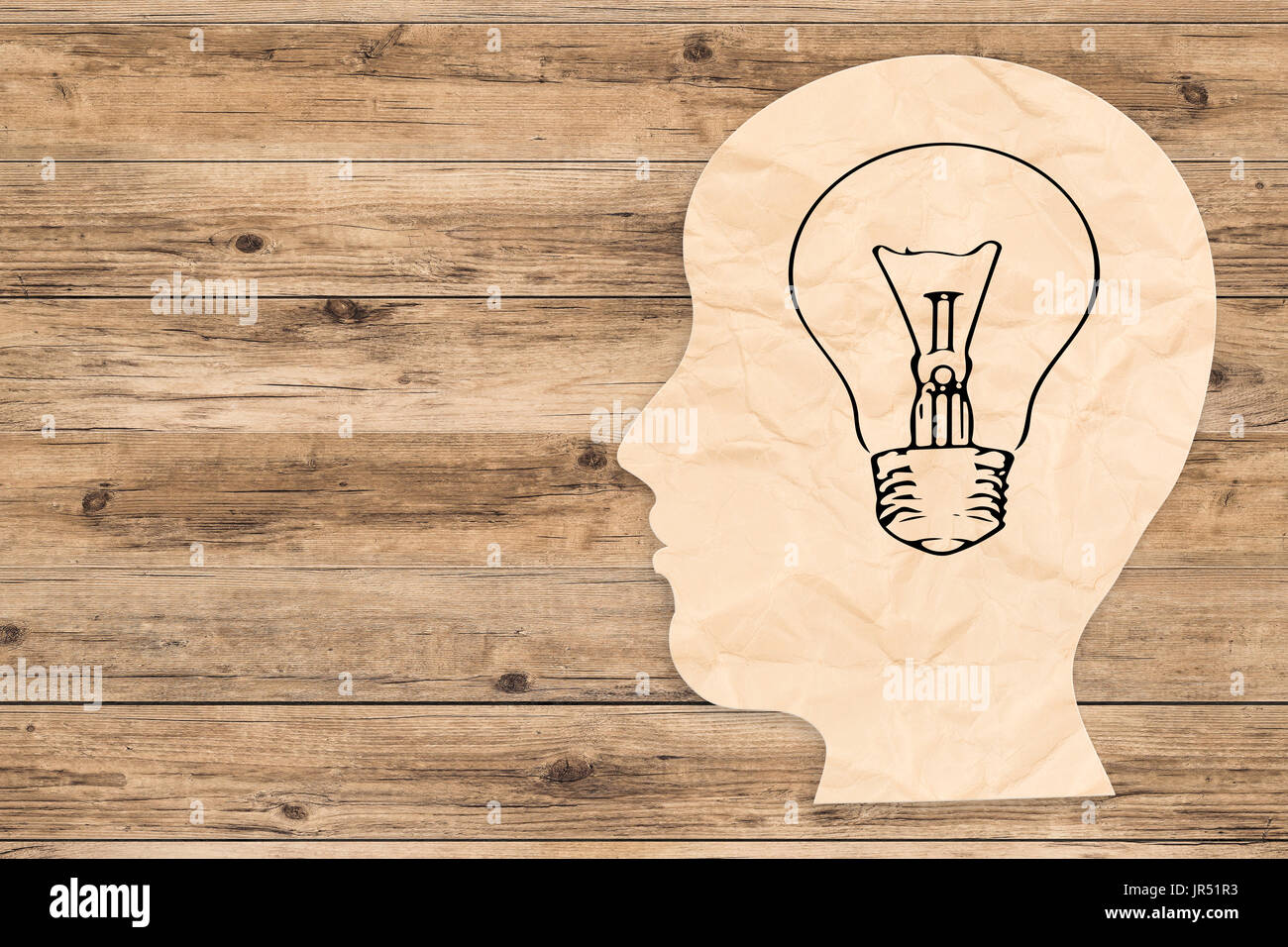 idea concept with side face and light bulb on wooden background Stock Photo