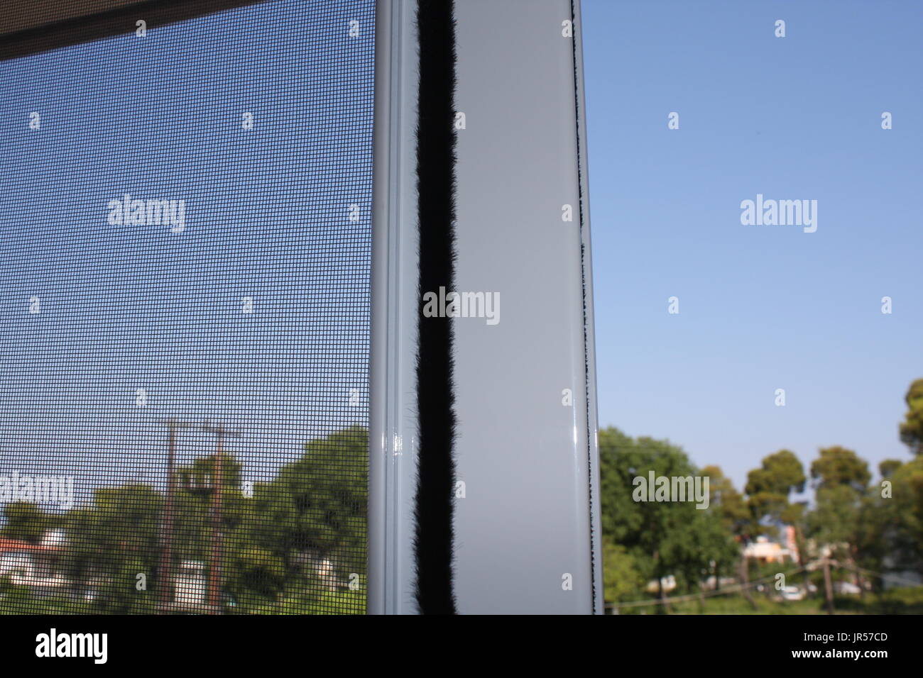 Installing mosquito nets for plastic windows Stock Photo Alamy