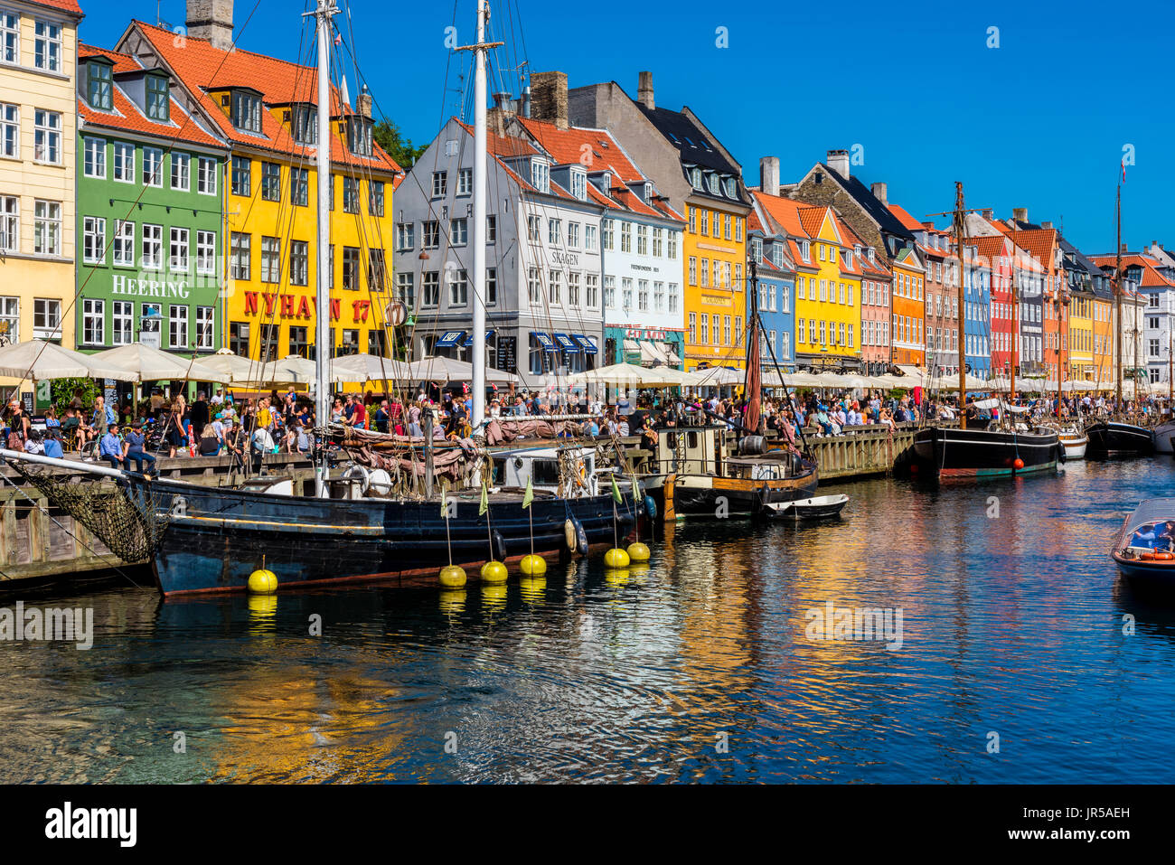 Nyhavn harbor and promenade in Copenhagen, Denmark. Nyhavn is the most famous landmark of Copenhagen. Stock Photo