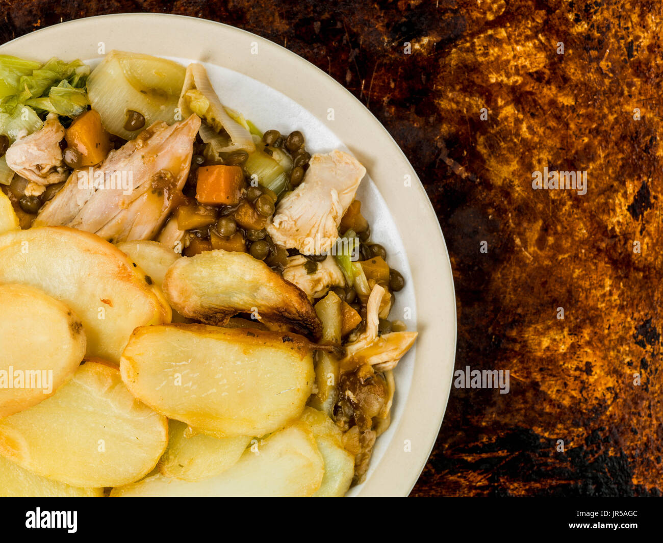 Chicken and Vegetable Hotpot With a Lentil Gravy Against a Distressed