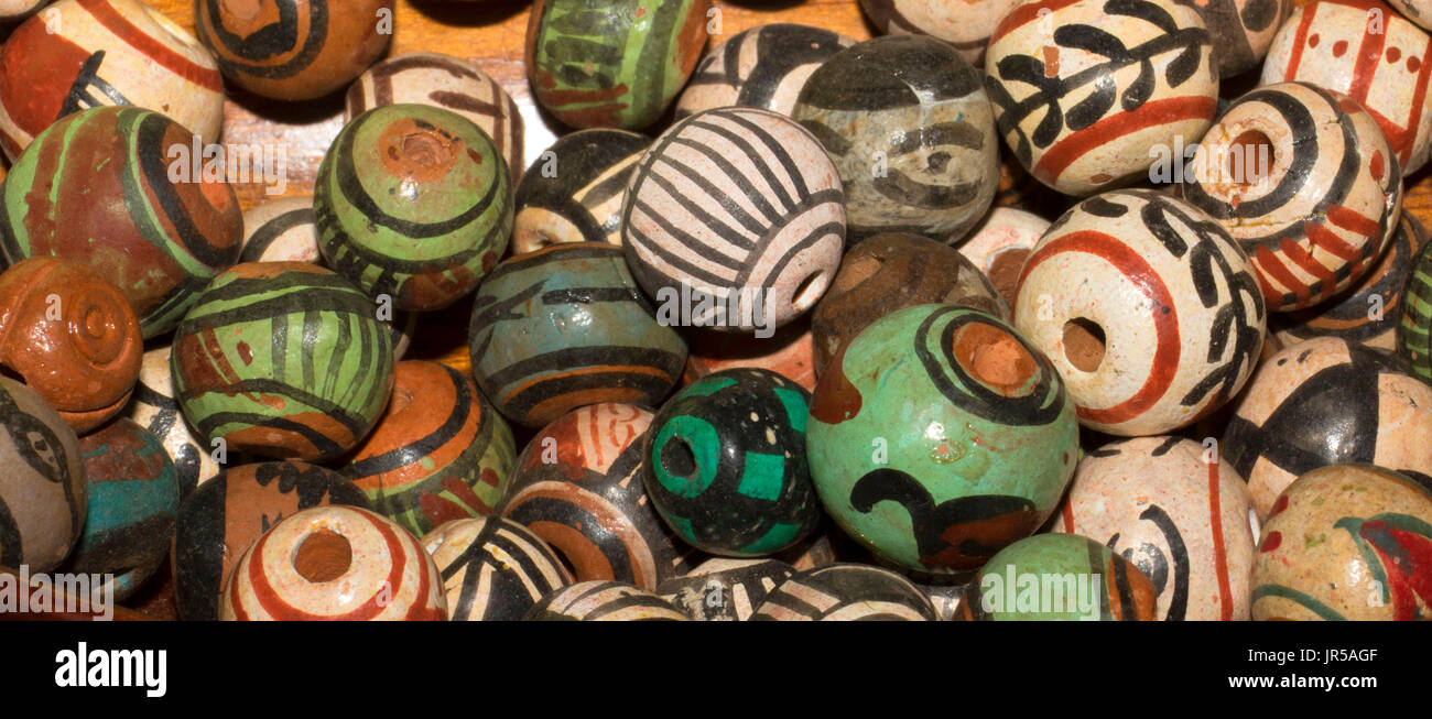 Glass and clay beads of different shapes and colors displayed in bulk at  local fair Stock Photo - Alamy