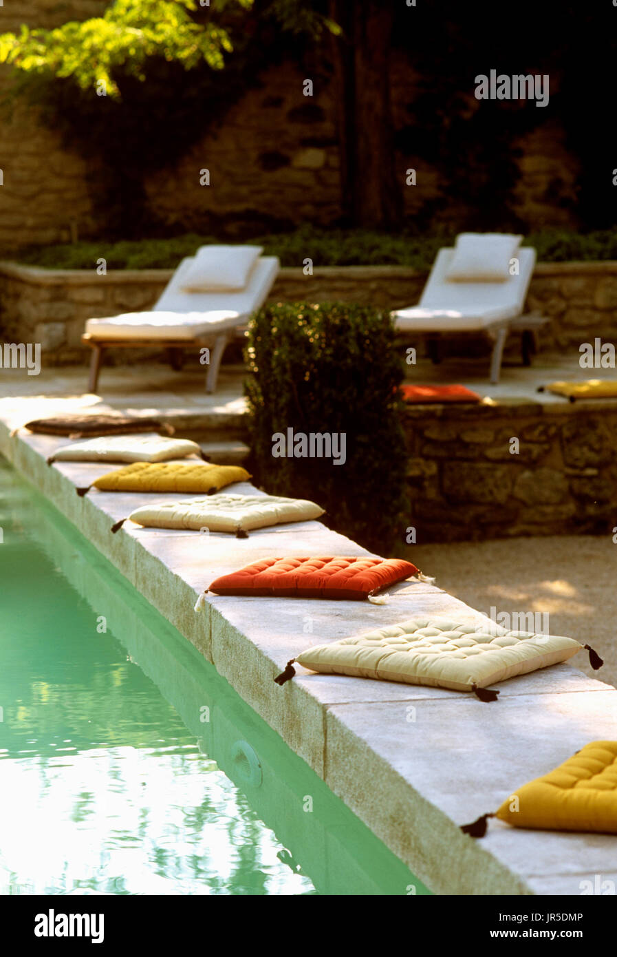 Cushions lining the edge of a swimming pool Stock Photo - Alamy