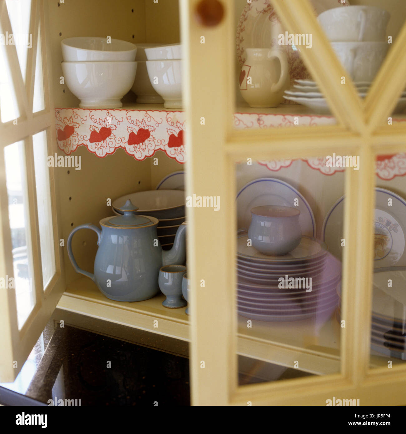 Open cupboard of tableware Stock Photo