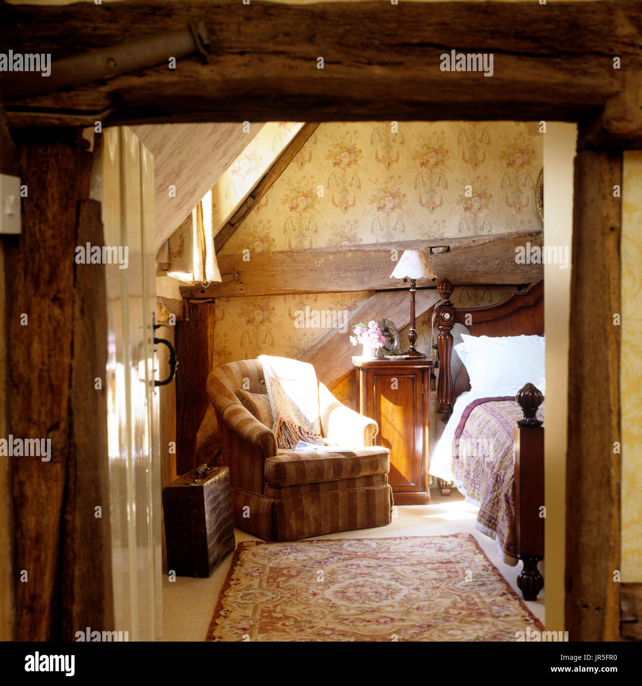 Armchair in rustic bedroom Stock Photo Alamy