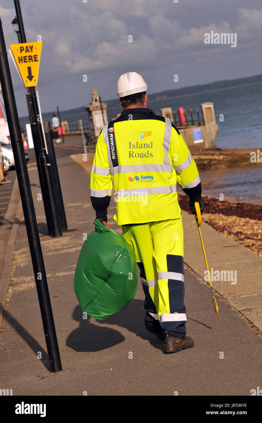 a man wearing protective clothing and a hard hat working for on the isle of wight on a hot day