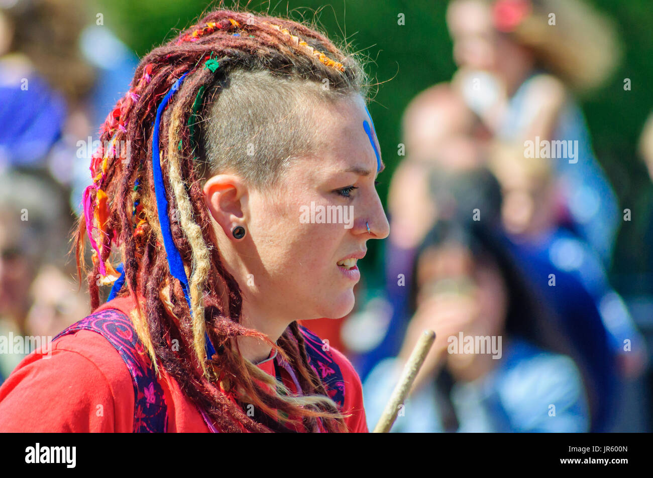 Female performer with shaved and dreadlock hairstyle in Edinburgh during  the Carnival of The Jazz and Blues Festival Stock Photo - Alamy