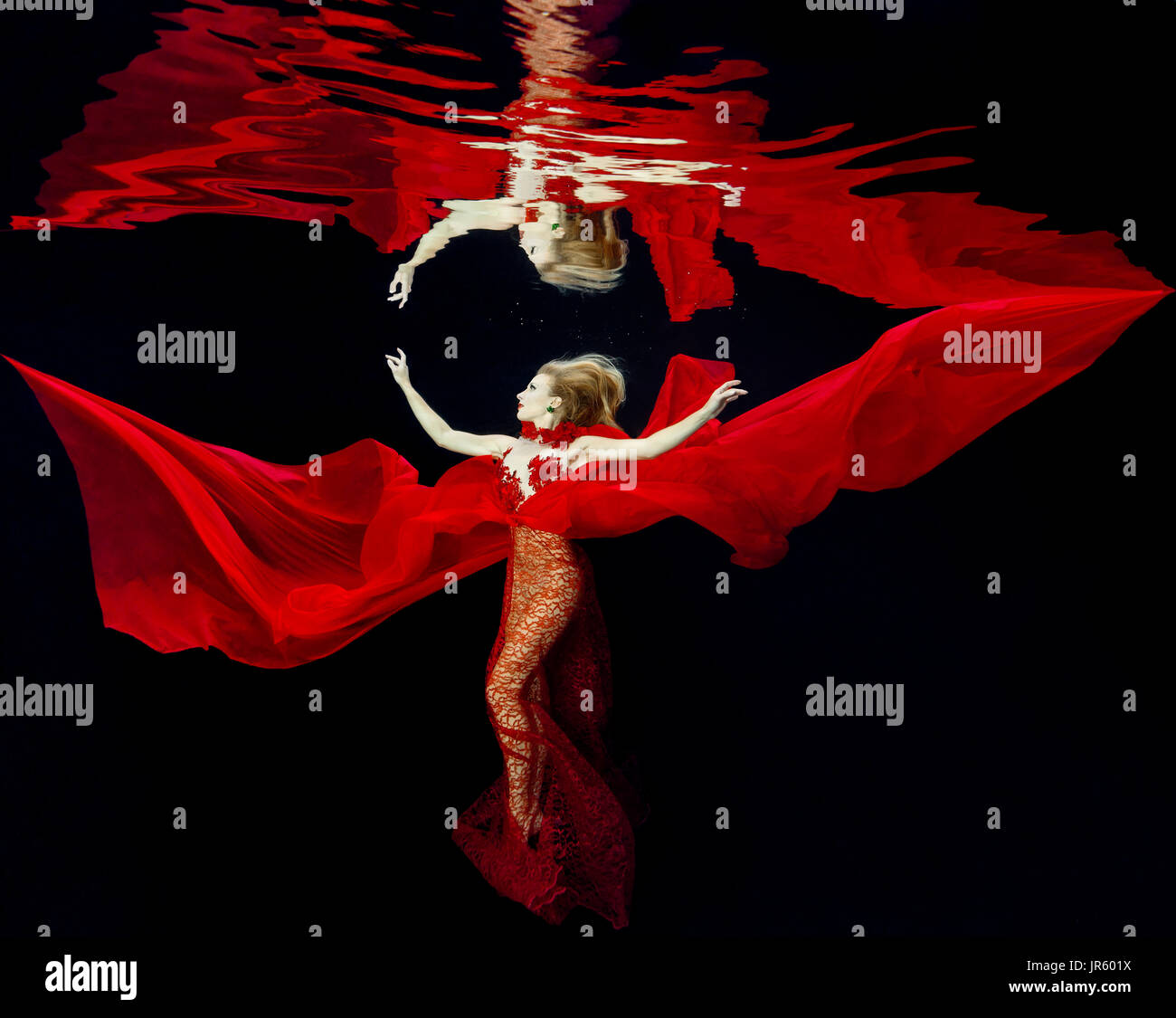 Woman in a red dress in the pool Stock Photo - Alamy