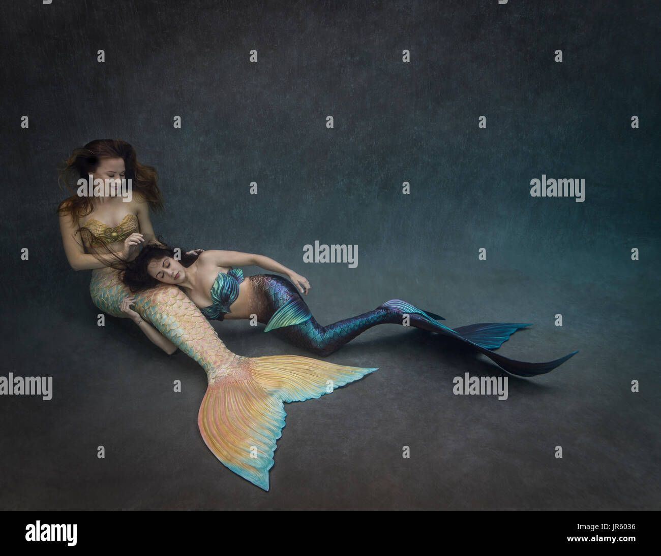 Two young mermaids relaxing together Stock Photo
