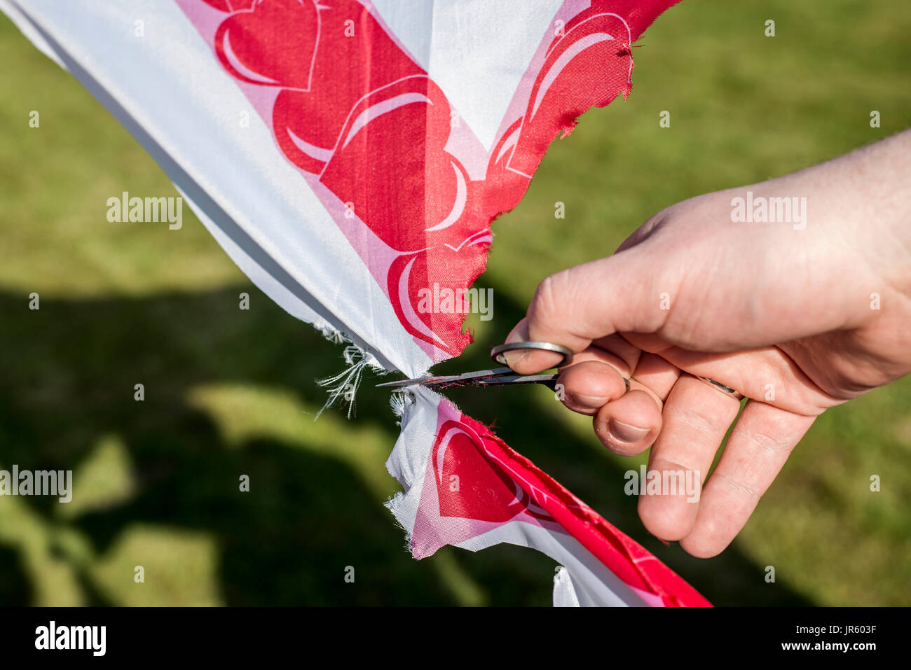 man cuts scissors finger hand on wedding tradition cutout heart detail closeup Stock Photo Alamy