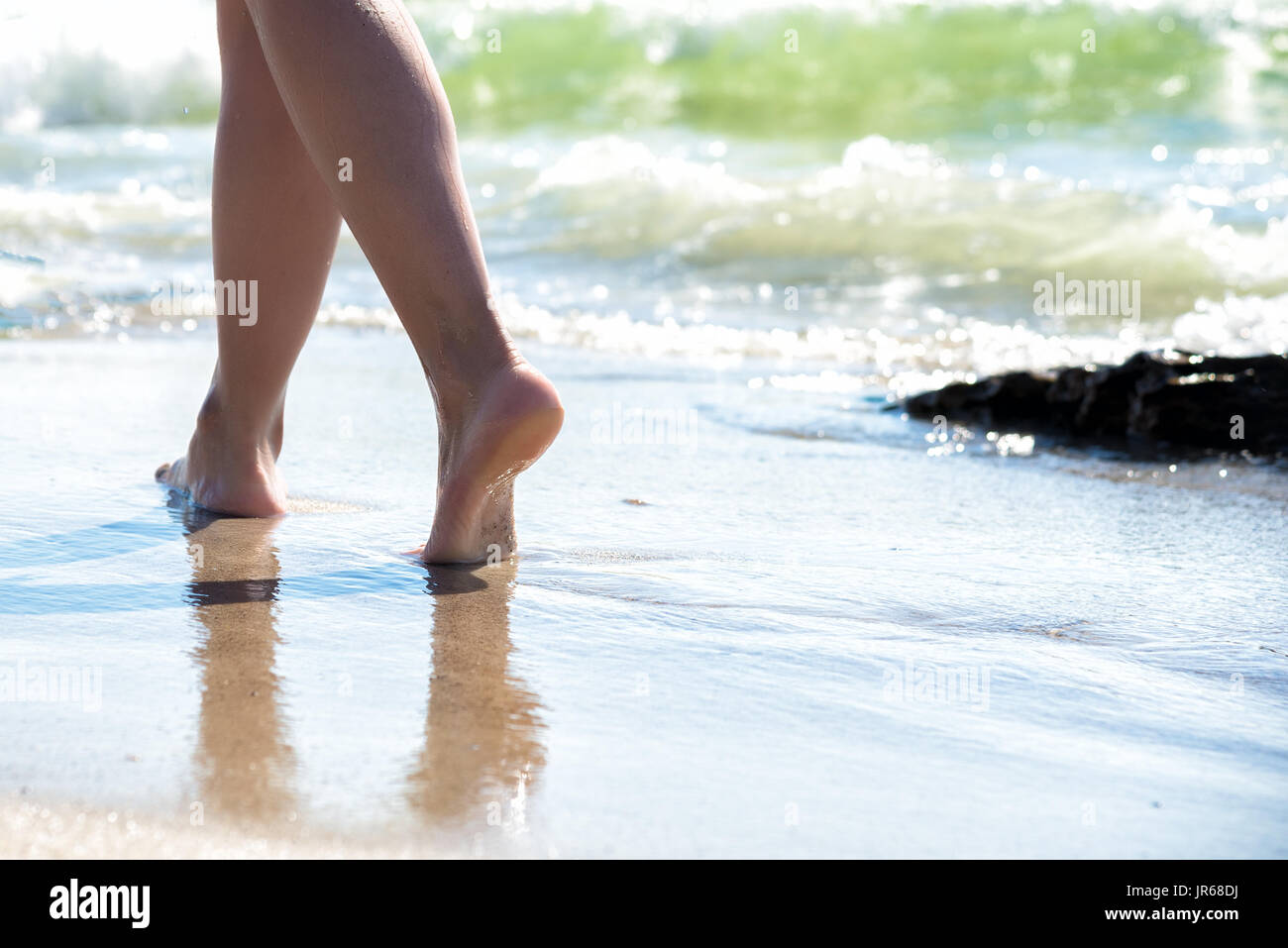 Woman Walking On Sand Beach Leaving Footprints In The Sand Stock Photo ...