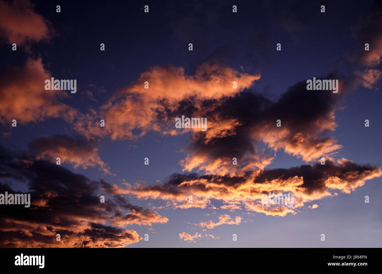 evening sky with orange-coloured clouds, could also be morning sky Stock Photo