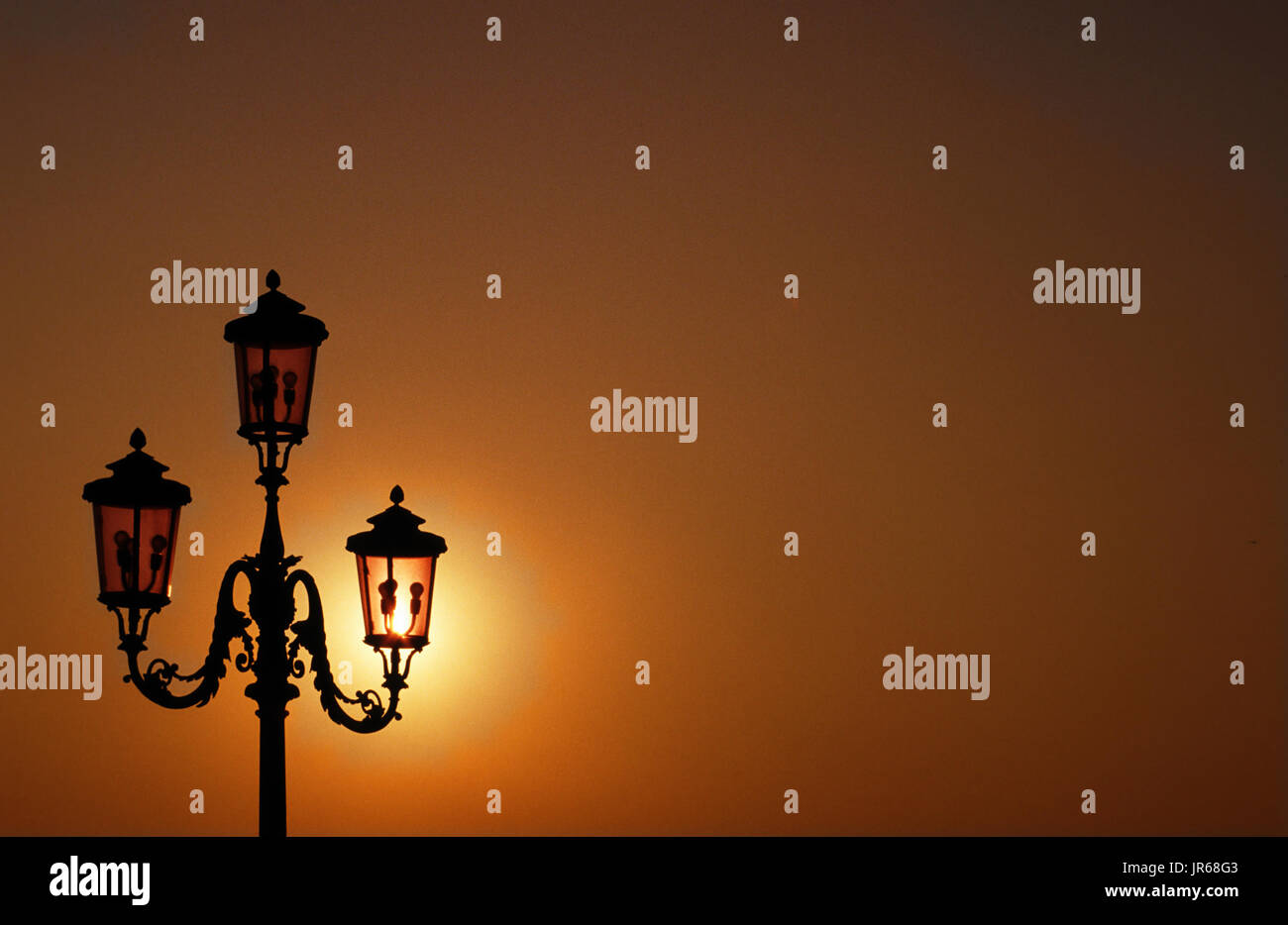 Venice: Sunset behind 3-armed lantern (Fanali), mood Stock Photo