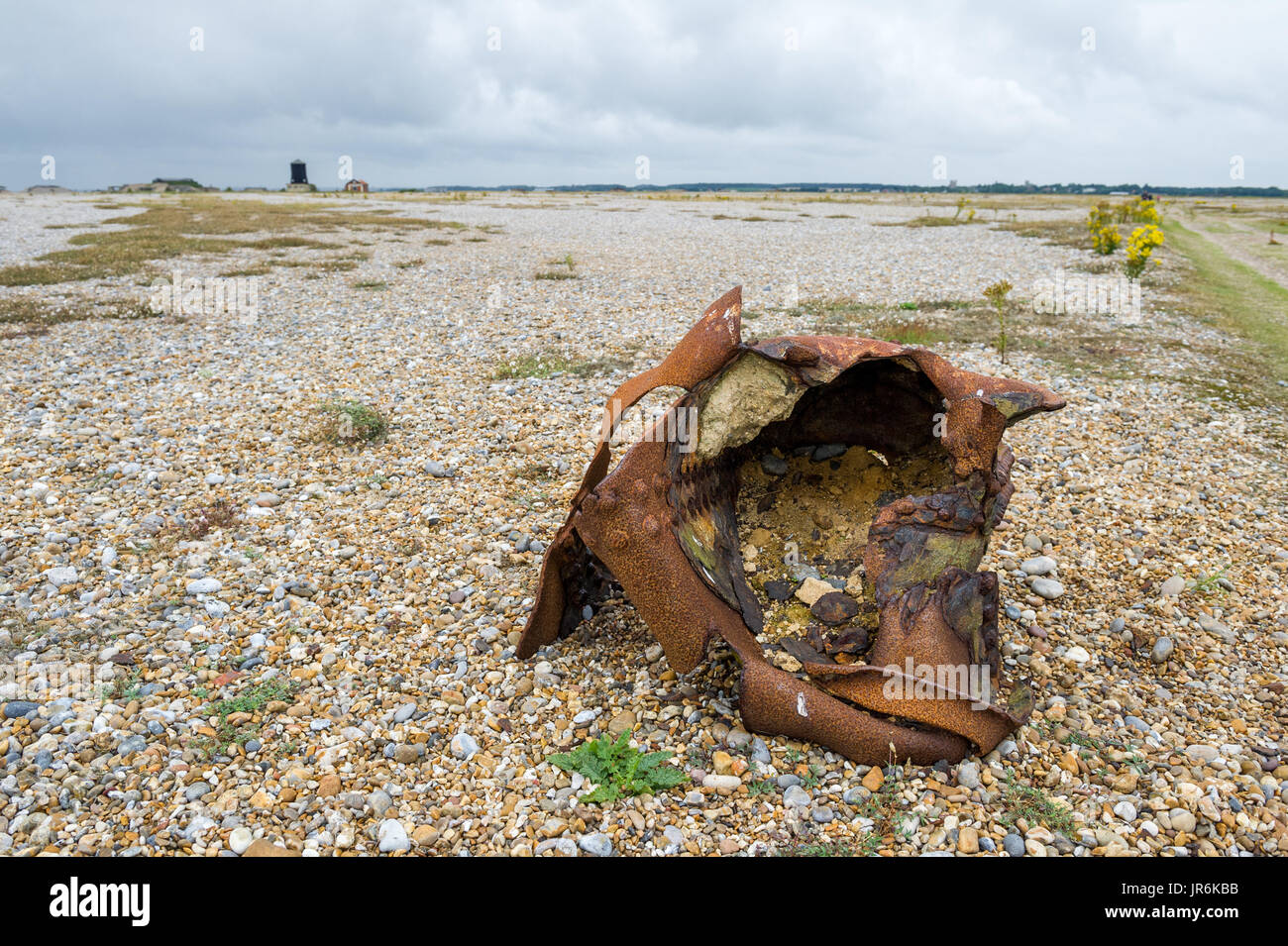 Damaged steel canister left on the shingle beach at Orford Ness, Orford Stock Photo