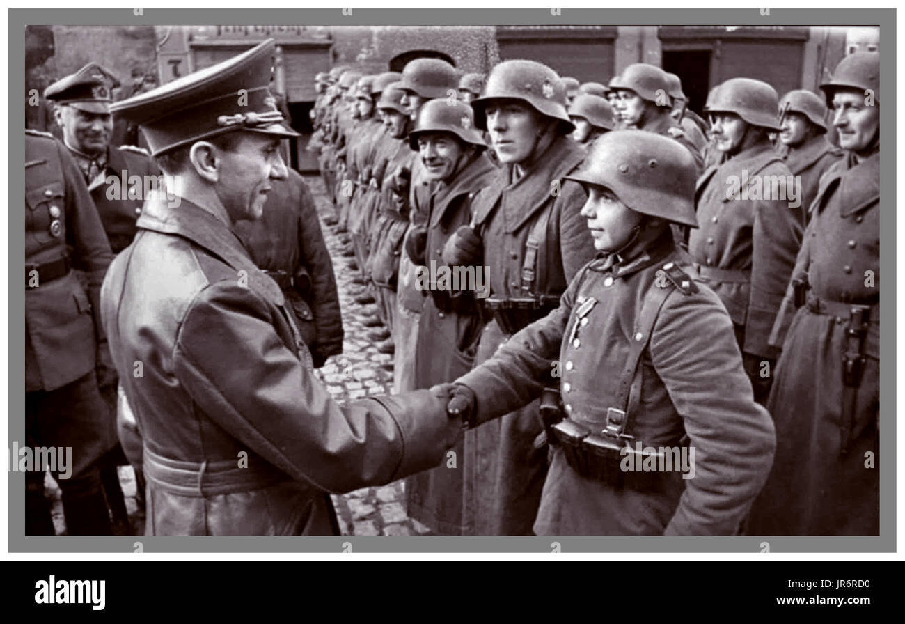 GOEBBELS AWARDS IRON CROSS Nazi Germany's propaganda minister Dr. Joseph Goebbels in uniform congratulates 16-year-old Wehrmacht soldier Wilhelm Hübner after awarding him the Iron Cross 2nd Class Stock Photo