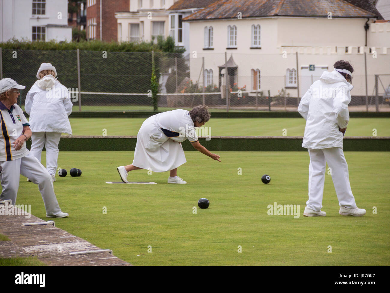 Sidmouth, Devon, UK. 4th Aug, 2017.  Rain doesn't stop play. The ladies at Sidmouth Bowls Club carry on despite the onset of a rain shower. Brighter and drier conditions are forecast for the South West over the weekend. Credit: South West Photos/Alamy Live News Stock Photo