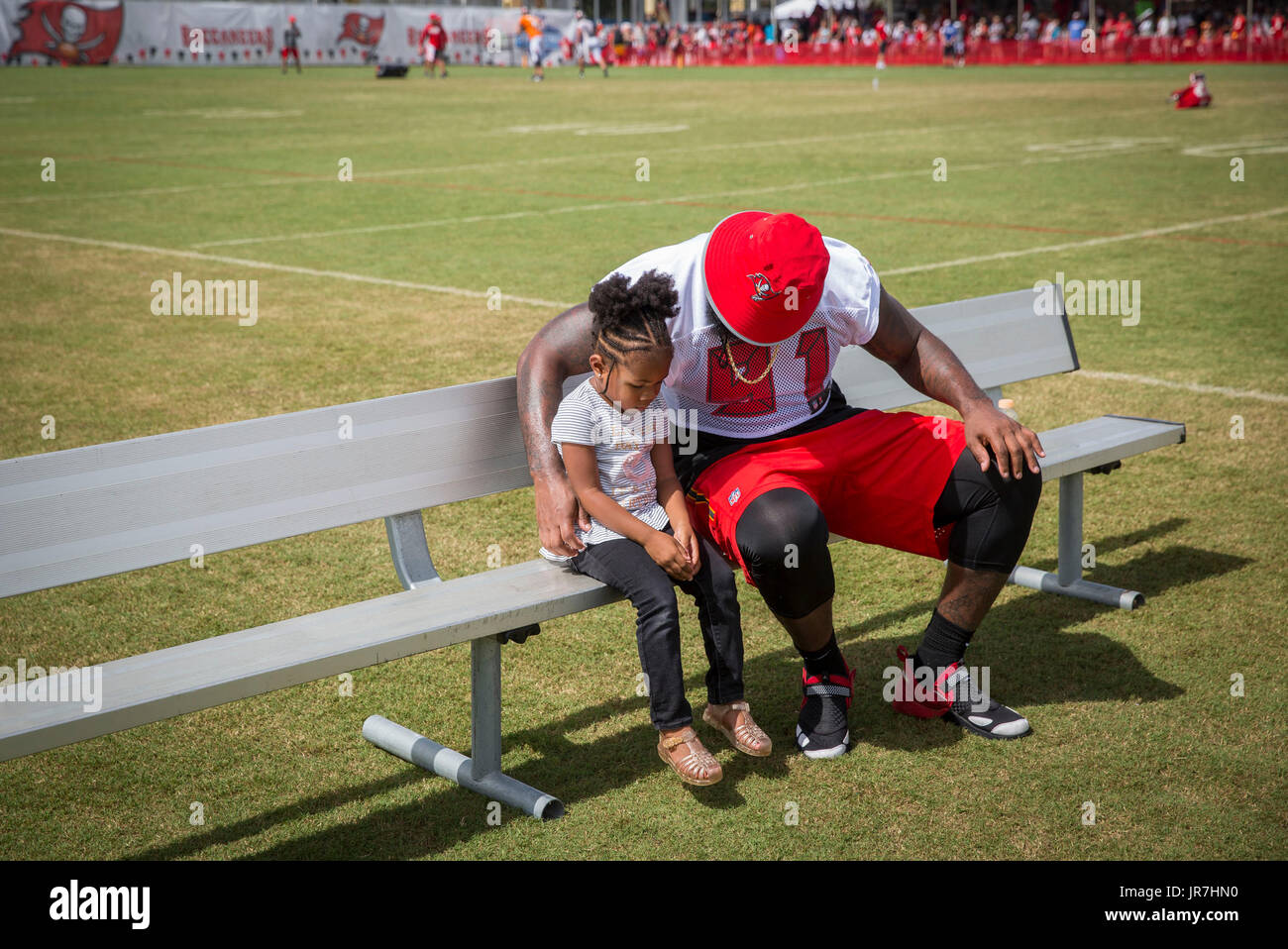 Florida, USA. 4th Aug, 2017. LOREN ELLIOTT | Times .Tampa Bay Buccaneers defensive end Robert Ayers (91) sits with daughter Brailyn, 3, after practice during training camp at One Buccaneer Place in Tampa, Fla., on Friday, Aug. 4, 2017. Credit: Loren Elliott/Tampa Bay Times/ZUMA Wire/Alamy Live News Stock Photo