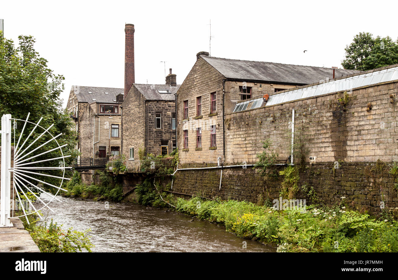 Industrial buildings and mills by the side of the River Calder, in Hebden Bridge, West Yorkshire, UK Stock Photo