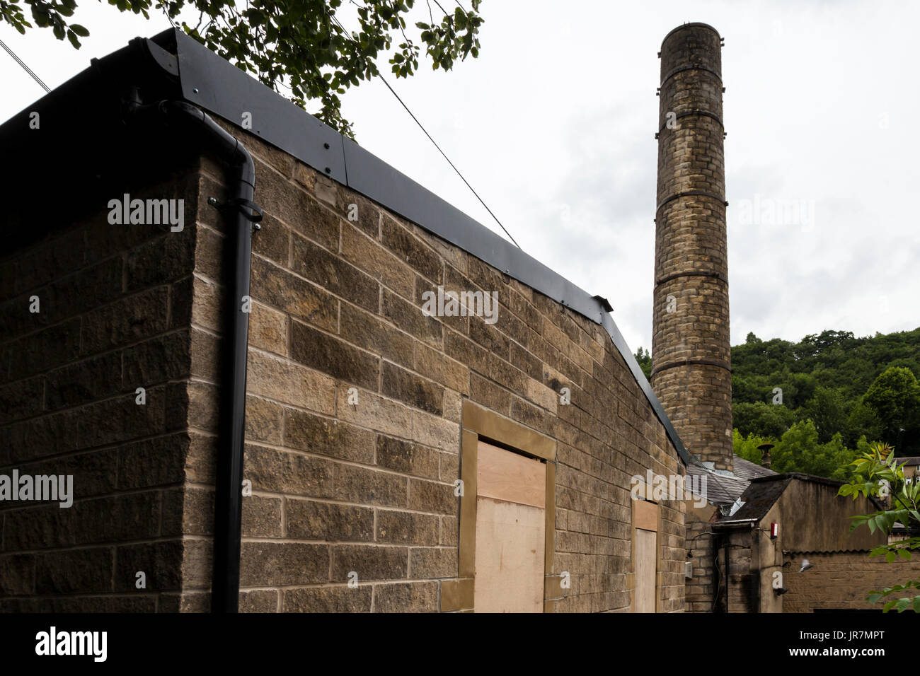 Industrial buildings and mills by the side of the River Calder, in Hebden Bridge, West Yorkshire, UK Stock Photo