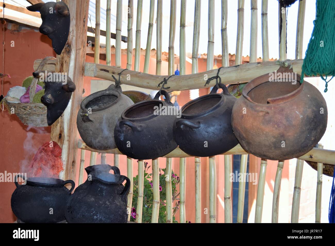 Rustic pots hanging at a market in Peru Stock Photo