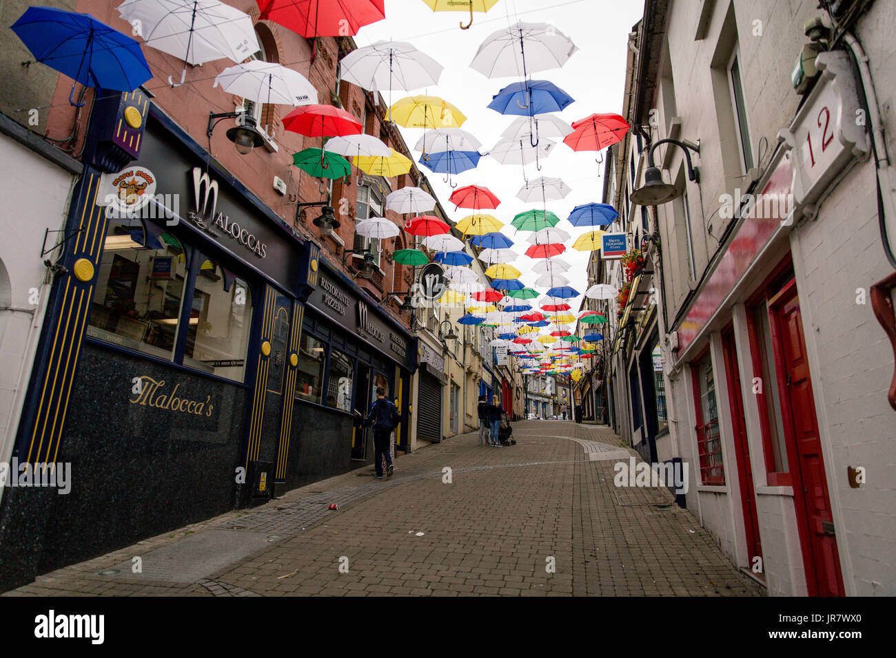 People walking through the street in Enniscorthy Ireland decorated with