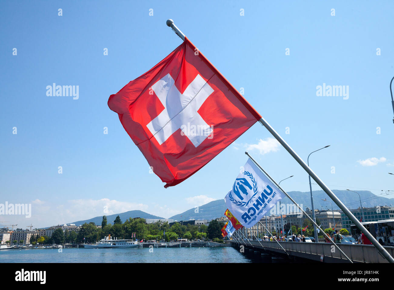 GENEVA, SWITZERLAND - JUNE 19, 2017: Swiss flag and UNHCR flags near leman lake in Geneva. The UNHCR is the agency of the United Nations in charge of  Stock Photo
