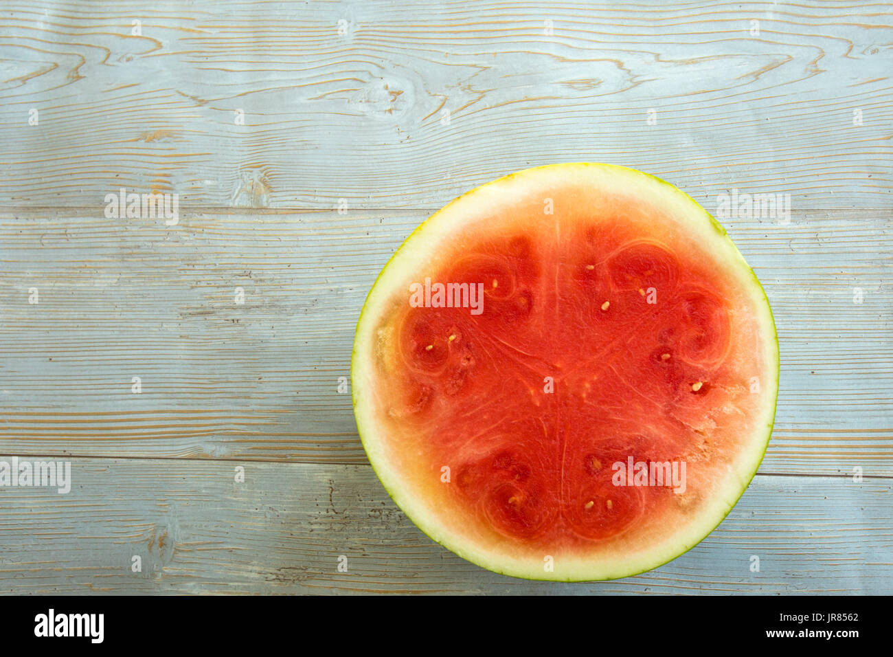 Slice of fresh watermelon on rustic blue painted wood slats Stock Photo ...