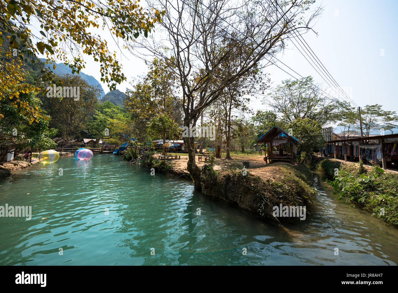 VANG VIENG, LAOS - MARCH 14, 2017:  Wide angle picture of small tent and colorful balls in Blue Lagoon, located close to the city of Vang Vieng, Laos. Stock Photo