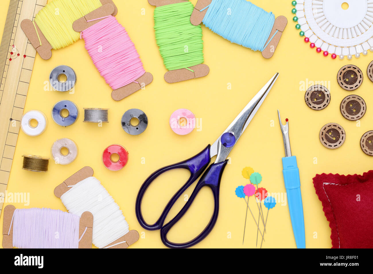 sewing tools, tailoring and fashion concept - close-up on yellow background Stock Photo