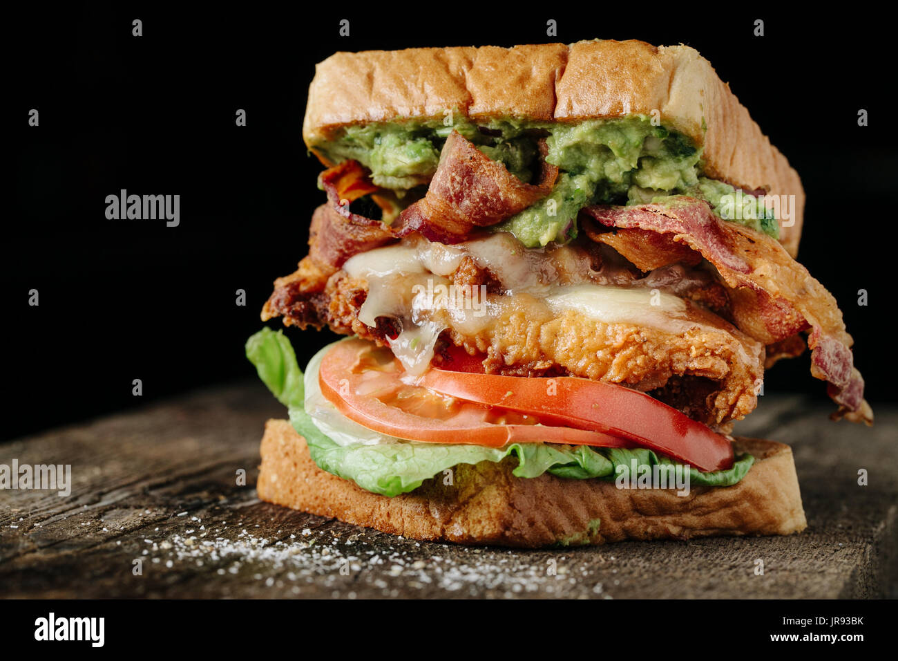Chicken and Avocado BLT sandwich on black background Stock Photo