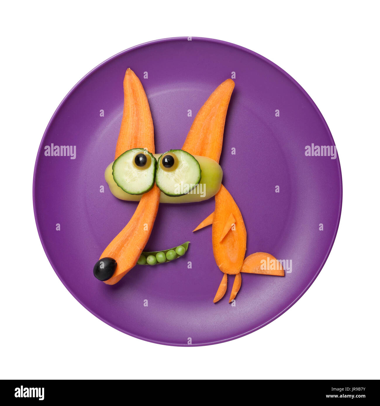 Fox made of raw carrots on plate Stock Photo