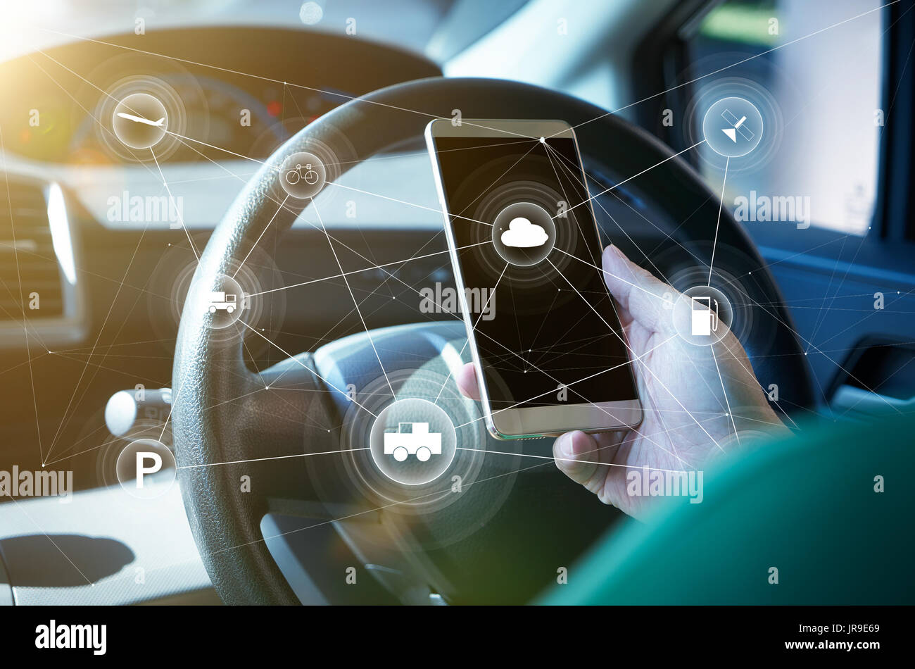 Man driver using smart self-driving car  control system on a hand phone. Futuristic driving technology concept . Stock Photo
